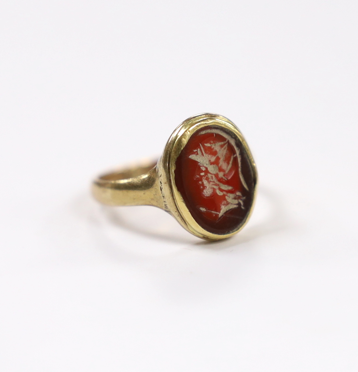 An antique 9ct and intaglio glass? set oval ring, depicting the bust of a Roman soldier to dexter, size P, gross weight 3.8 grams.